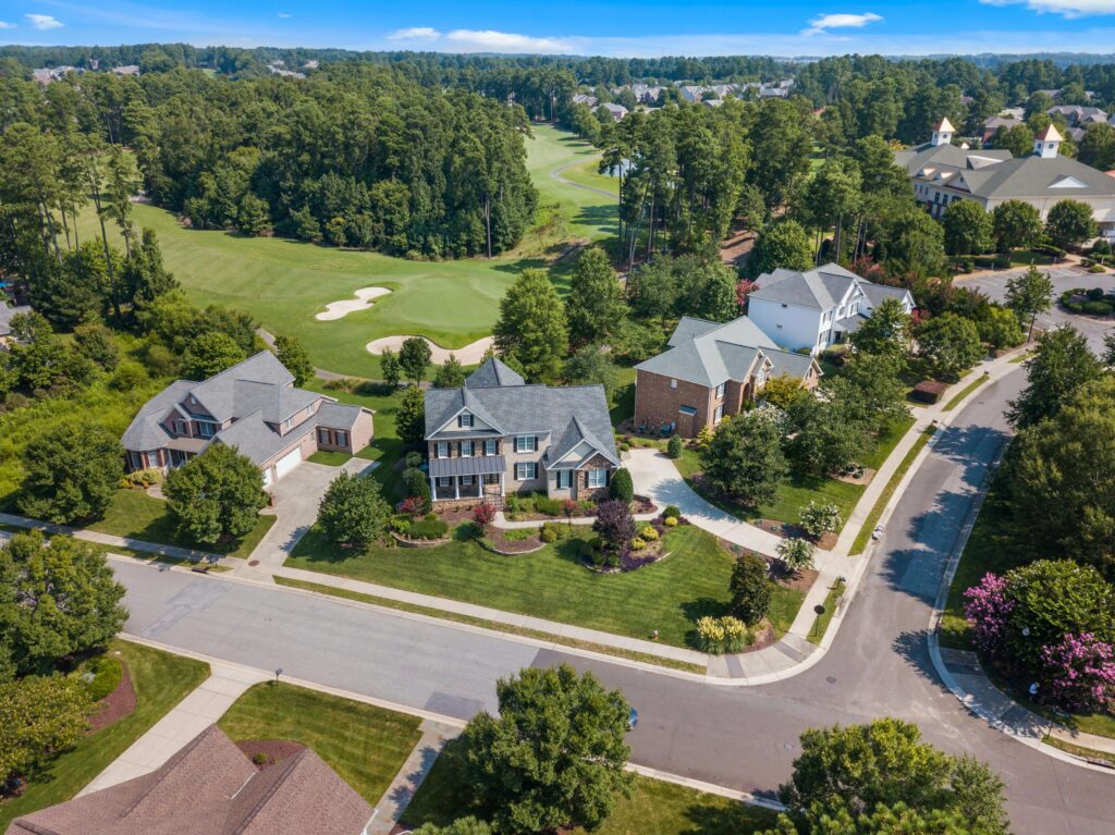 Aerial view of a suburban community showing greenery and curved roads, symbolizing good feng shui neighborhood energy.