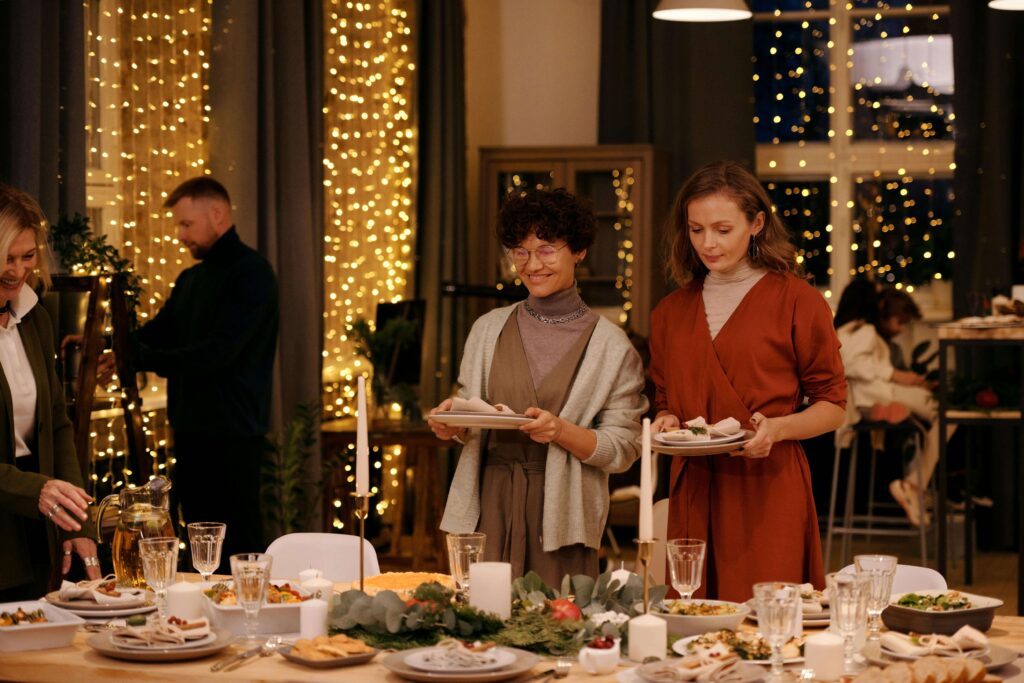 Family gathering around a Thanksgiving dining table with warm lighting and festive decor for Thanksgiving Feng Shui
