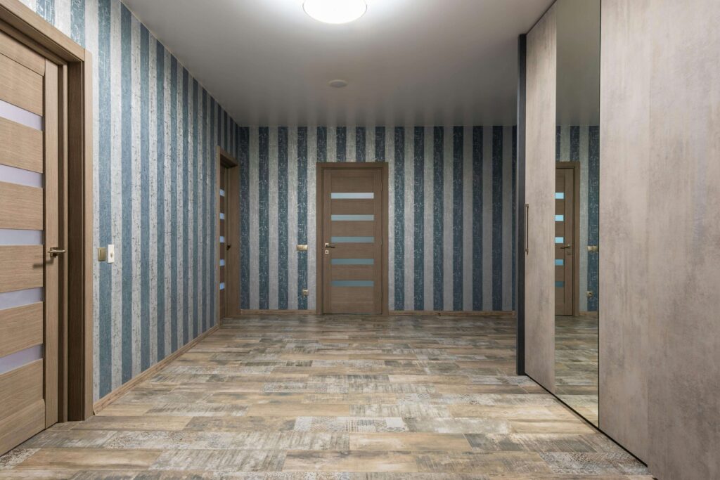“Apartment hallway with multiple doors facing each other, symbolizing restless and unstable energy flow in condo Feng Shui.”