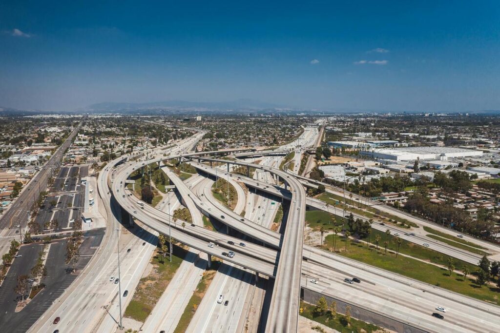 Aerial view of a busy highway interchange with heavy traffic, symbolizing chaotic energy flow in Feng Shui.