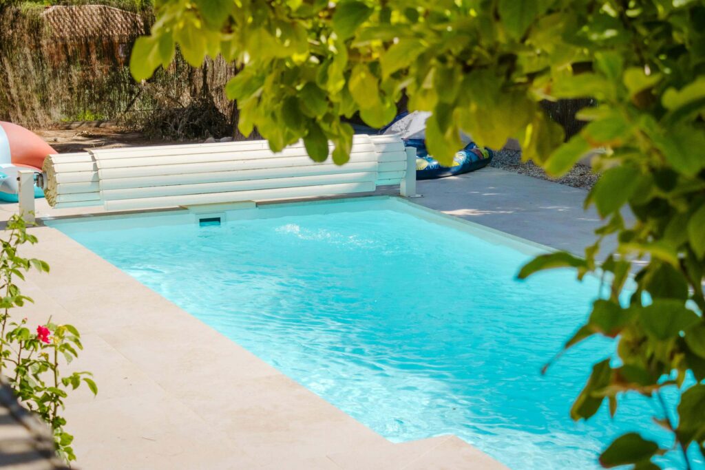 A clean rectangular backyard swimming pool surrounded by greenery, symbolizing balance and positive Feng Shui energy.