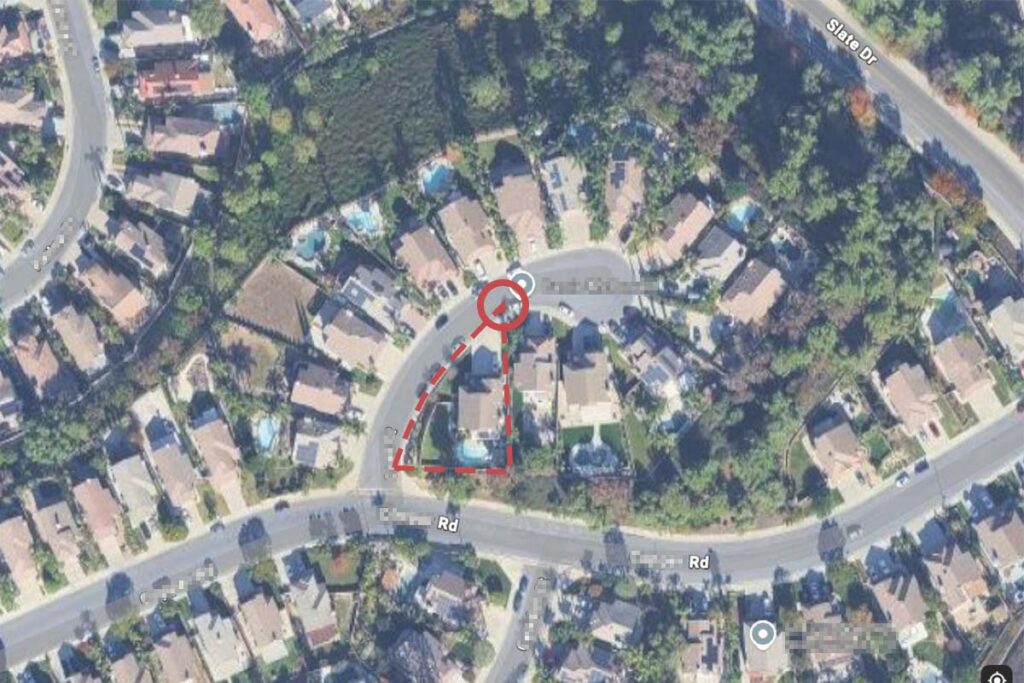 Aerial view of a triangular residential lot in a cul-de-sac highlighting a sharp-angled property shape.
